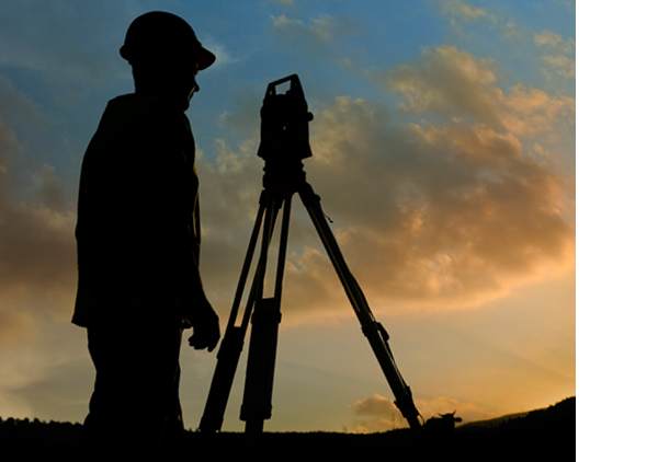 A land surveyor using total station equipment for property surveys